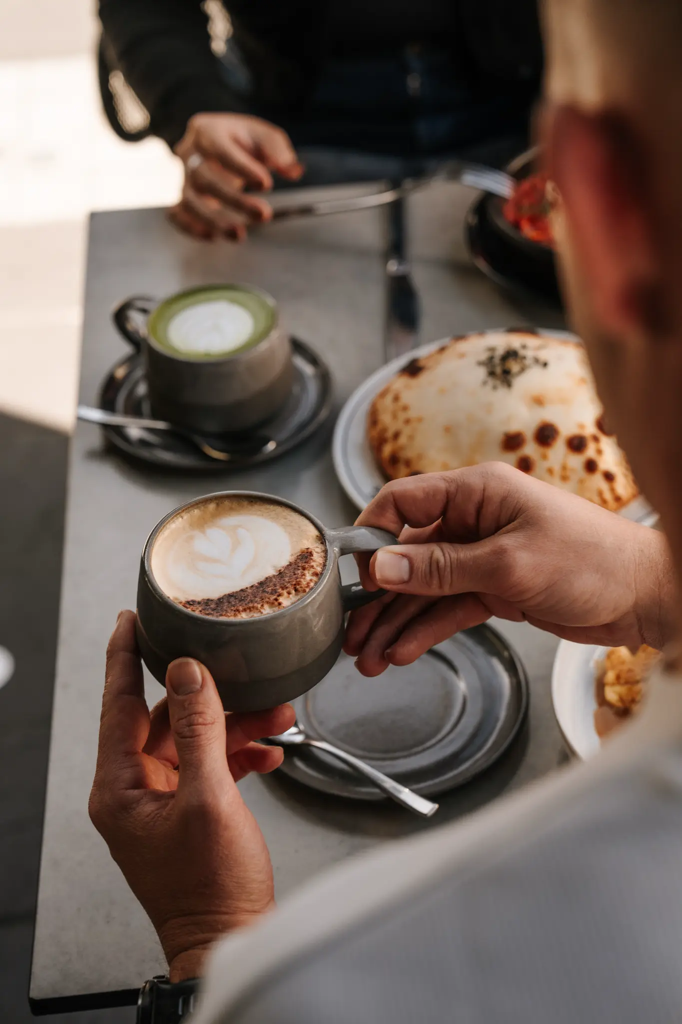 Guests sharing coffee and flatbread at Stella brunch