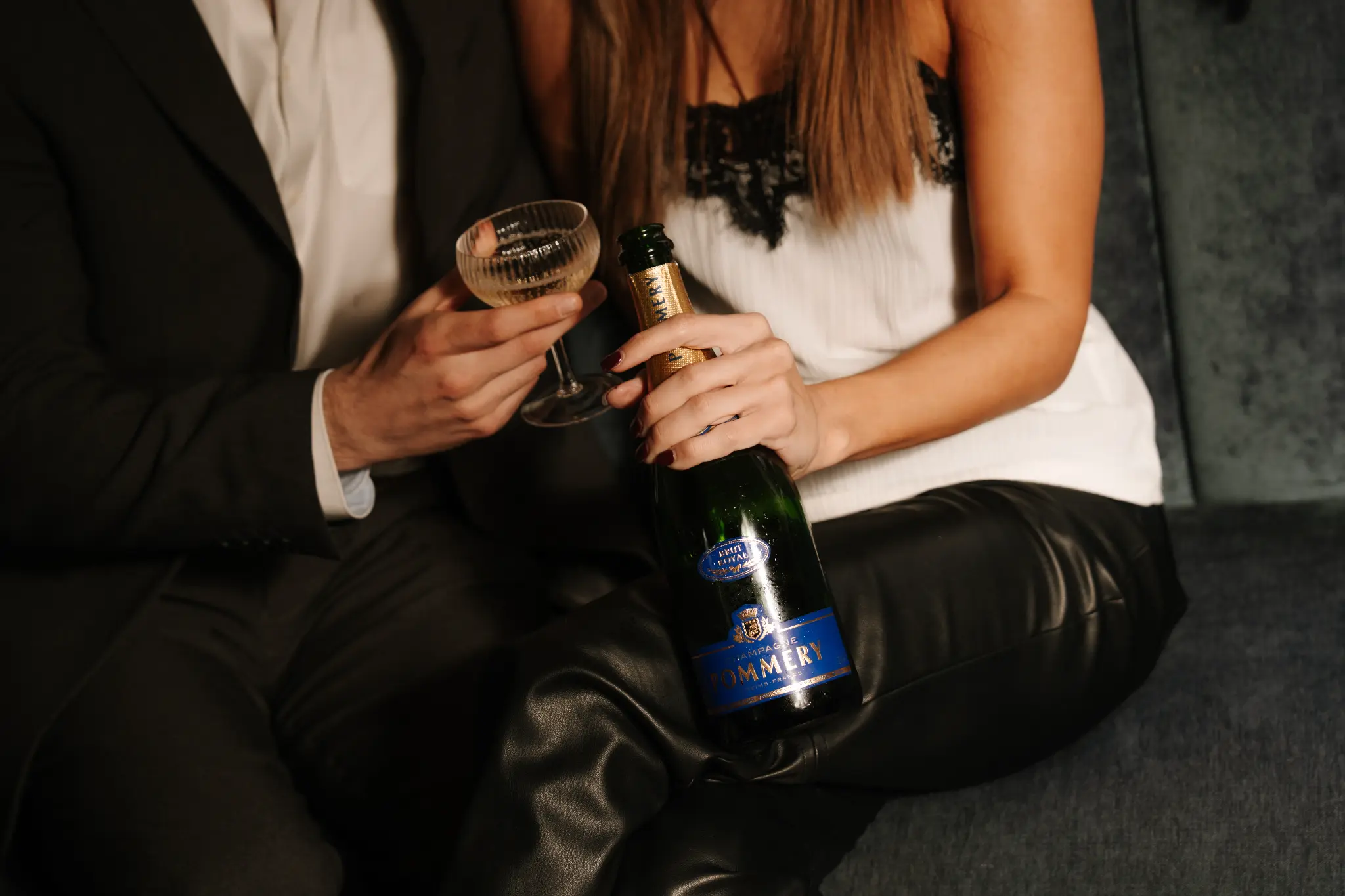 Guests holding a bottle of Champagne Pommery in Stella Cocktail Lounge