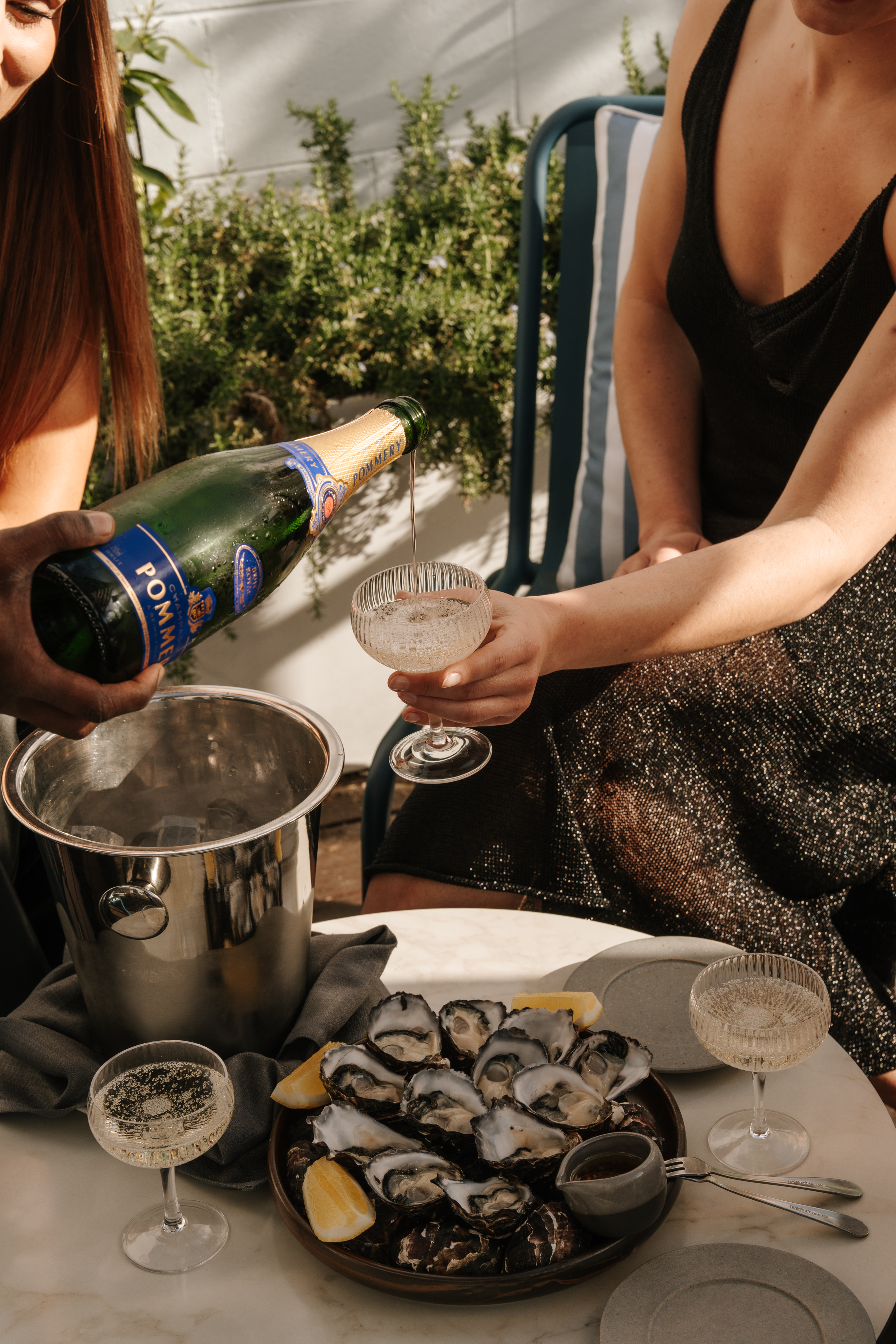 Pommery Champagne being poured beside fresh oysters on Stella Rooftop in South Yarra